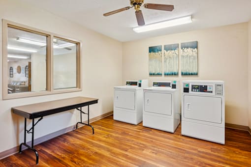On-site laundry facility at Blairwood Apartments in Louisville, featuring washers and dryers in a clean, well-maintained space.