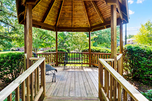 Outdoor gazebo with seating area at Blairwood Apartments in Louisville, surrounded by trees and landscaped grounds.