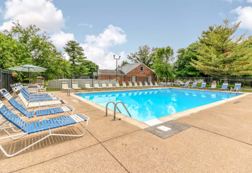 Outdoor swimming pool with seating at Ashley Pointe Apartments