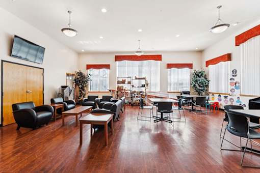 A room with wooden floors and furniture.