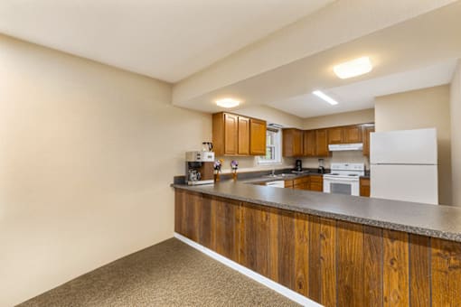 A kitchen with wooden cabinets and a white refrigerator.