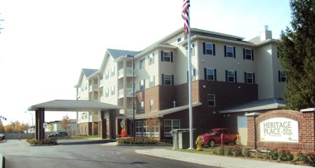 A building with the sign "Heritage Place" in front of it.
