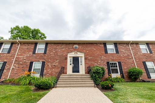 A red brick building with a black door and windows.