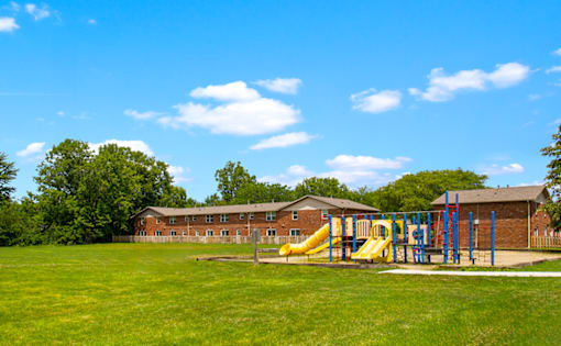Playground at Bradford Lake Apartments featuring slides and climbing structures.