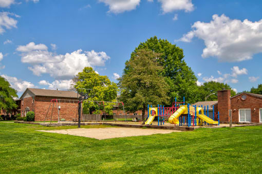 Playground with swing sets and slides at Bradford Lake Apartments