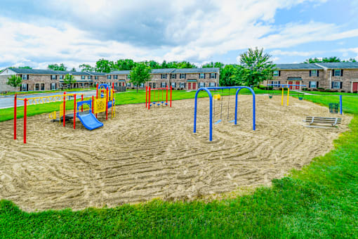 Playground at Jamestown Valparaiso  featuring slides, swings, and climbing structures.
