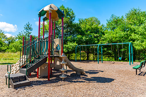 Playground at North Lake Apartments with slides and swings.