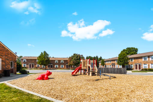 Playground at Richfield Apartments in Fort Wayne, featuring colorful play equipment and play area for children.