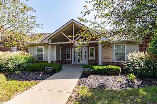 A house with a front yard and a walkway leading to the front door.