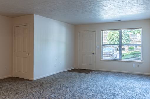 A room with two doors and a window.