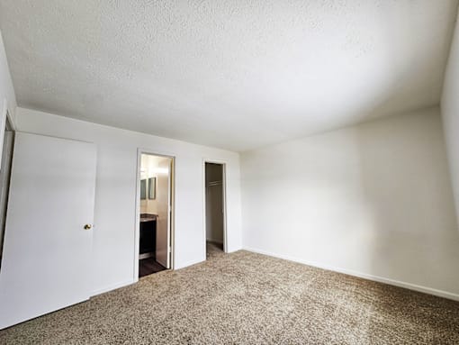 A room with carpeted floor and white walls.