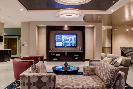 Spacious and luxurious lobby with a television and ample seating at Quarry at River North