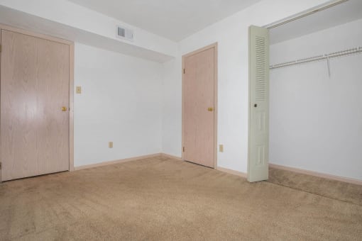 Secondary bedroom with a closet in a 2-bedroom apartment at King's Landing Apartments.