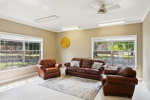 Social lobby at Carriage House Apartments in La Porte, IN featuring comfortable seating.