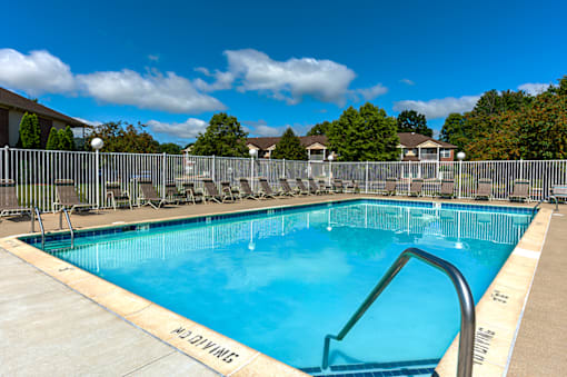 Swimming pool with seating at North Lake Apartments.