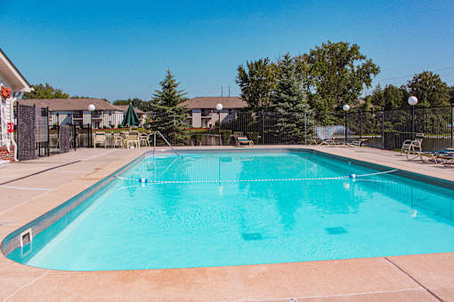 A large swimming pool with a blue tinted water.