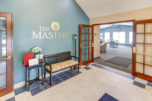 A reception area with a bench and a sign that says