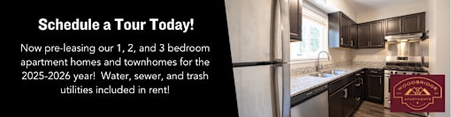 A sign in a kitchen advertises a tour of a 1, 2, and 3 bedroom apartment.