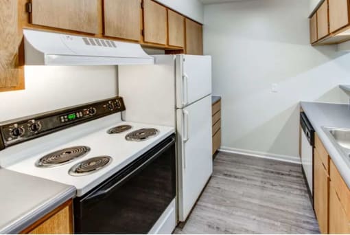a kitchen with a stove and a refrigerator