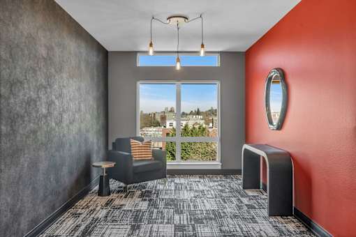 Resident lounge with seating and large windows at The Lyric Apartments, Seattle, Washington