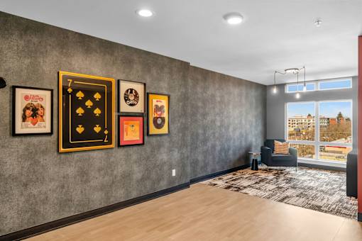 Community lounge with gallery wall art at The Lyric Apartments, Seattle