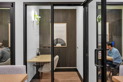 Private work booth with desk and acoustic paneling at The Lyric Apartments, Seattle, WA
