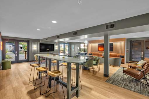 Communal gathering space with high top tables and lounge areas at The Lyric Apartments, Washington, 98102