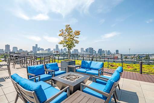 Rooftop terrace with blue seating and fire pit at The Lyric Apartments, Seattle