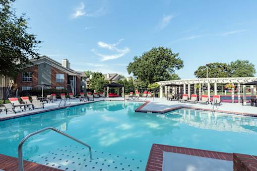 A large swimming pool with a metal ladder in the middle of it.