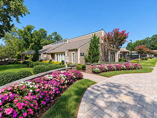 A residential building with a garden in front.