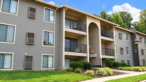 Apartment building with a balcony on the second floor.