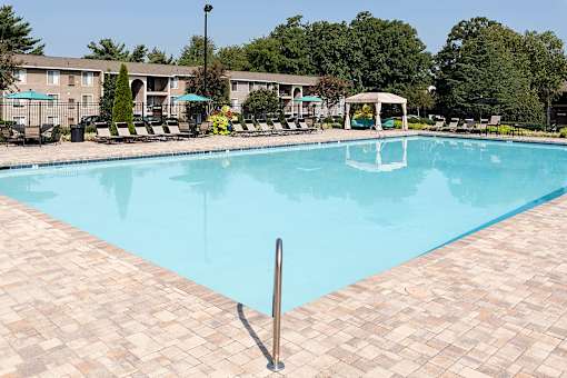 A large rectangular pool with a black pole in the middle of it.