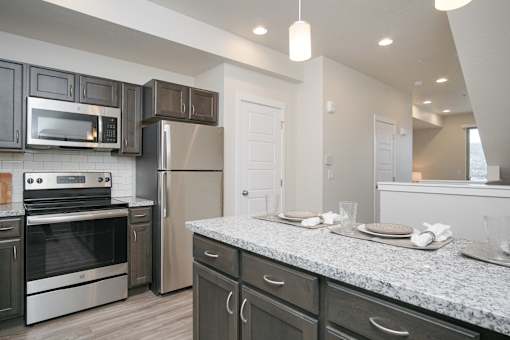 Modern kitchen with granite countertops at Liberty Point Apartments, Utah