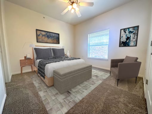 Liberty Landing Apartments Heathrow Floor Plan double bed with night table and chair. West Jordan, Utah.