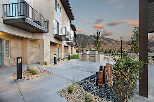 Outdoor courtyard with grilling station and water feature at Liberty Point Apartments, Draper, 84020