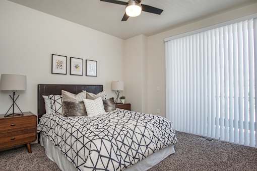 Bedroom with ceiling fan at Liberty Square Apartments - Saltlake City, UT Apartments, Saltlake City, UT, 84102