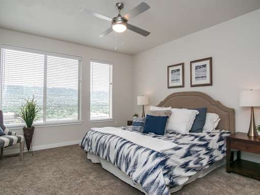 Spacious master bedroom with large windows at Liberty Point Apartments, Draper