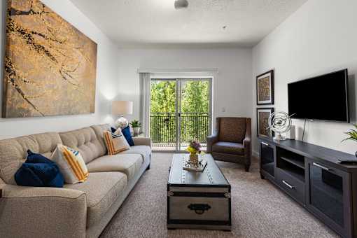 Living room with balcony and modern furnishings at Liberty Gateway Apartments, Salt Lake City