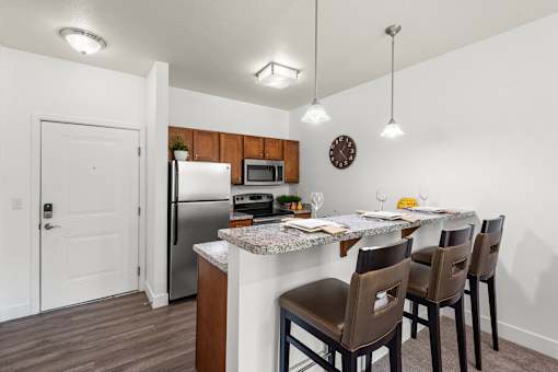 Open kitchen with breakfast bar and pendant lighting at Liberty Gateway Apartments, Utah, 84101