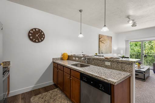 Kitchen island with granite countertop and dishwasher at Liberty Gateway Apartments, Salt Lake City, UT