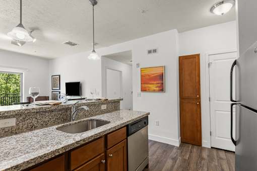 Kitchen featuring granite counters and wood cabinetry at Liberty Gateway Apartments, Salt Lake City, 84101