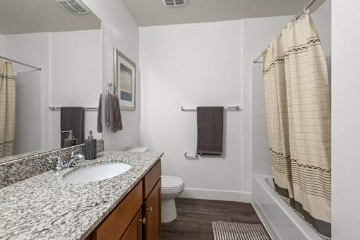 Bathroom with tub shower combo and granite counter at Liberty Gateway Apartments, Salt Lake City, UT 84101