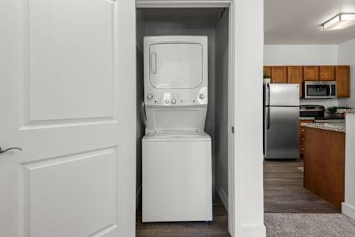Stacked washer and dryer in laundry closet at Liberty Gateway Apartments, Salt Lake City, UT