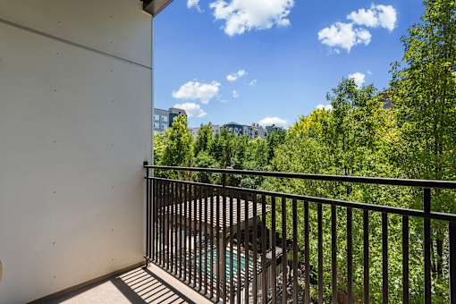 Balcony with metal railing overlooking trees at Liberty Gateway Apartments, Salt Lake City, 84101