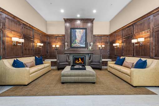 Lobby lounge with fireplace and wood paneling at Liberty Gateway Apartments, Salt Lake City, Utah