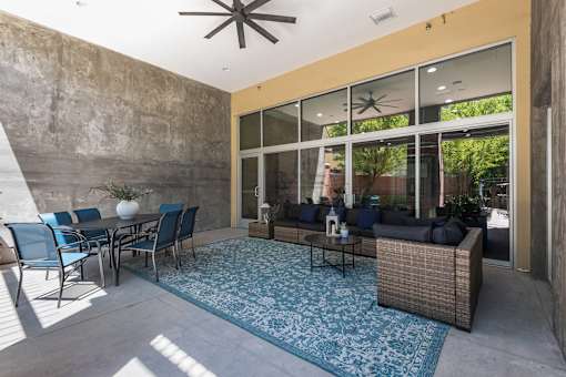 Covered patio with seating and ceiling fan at Liberty Gateway Apartments, Salt Lake City, UT