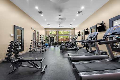 Fitness center with cardio equipment and free weights at Liberty Gateway Apartments, Salt Lake City