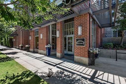 Brick building entrance with library signage at Liberty Gateway Apartments, Utah