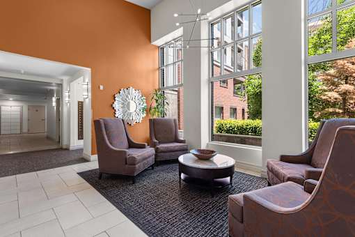 Welcoming lobby with contemporary seating and orange accent wall at Liberty Gateway Apartments, Salt Lake City, UT 84101
