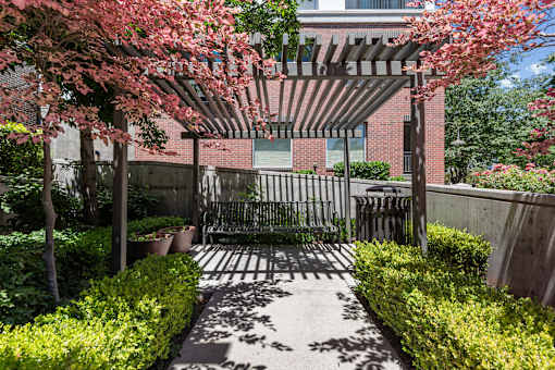 Garden courtyard with pergola and seating area at Liberty Gateway Apartments, Salt Lake City, UT